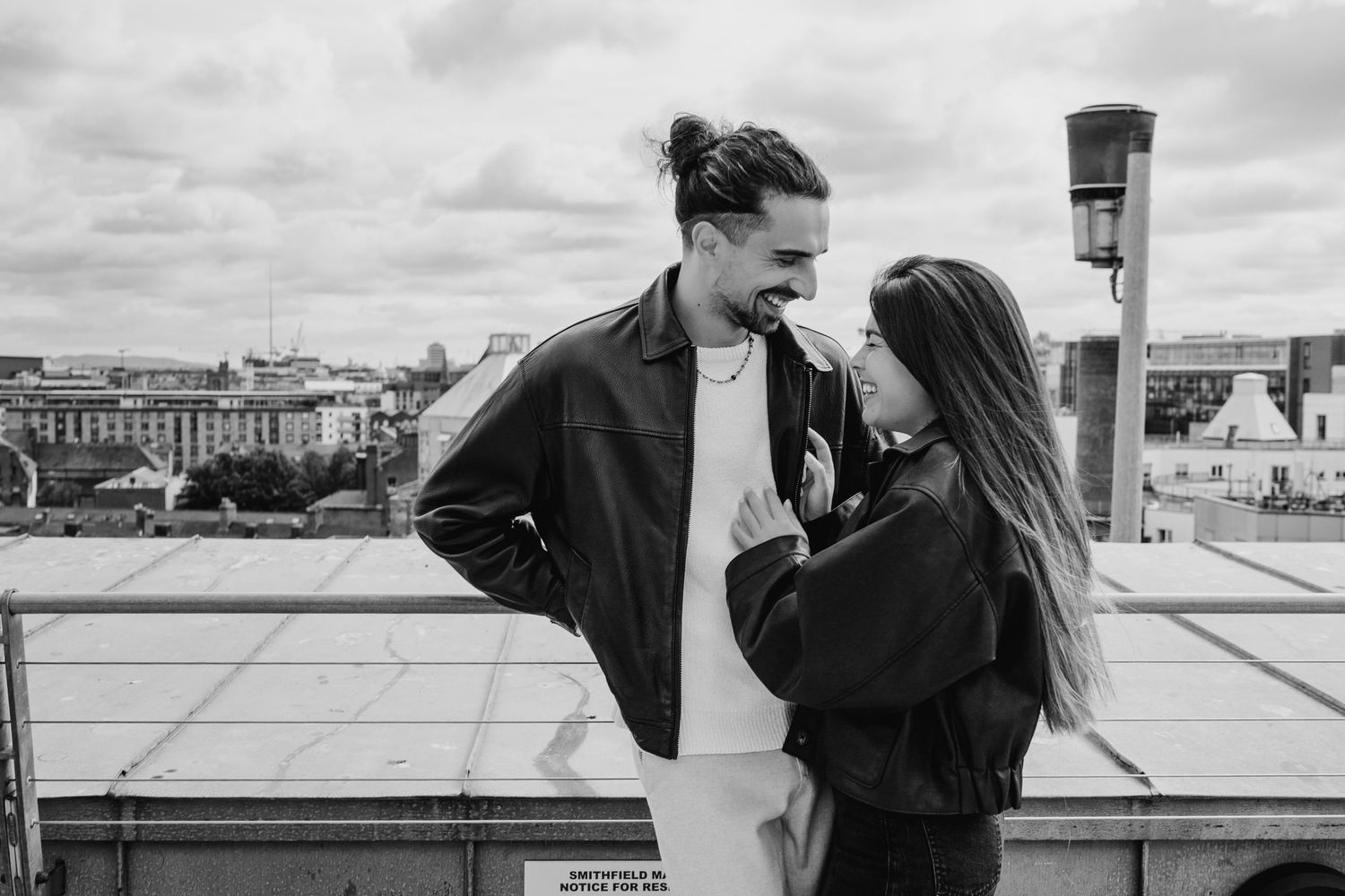 A couple shares intimate moments against an industrial urban backdrop. Couple's Photoshoot PHOTOGRAPHER Dublin