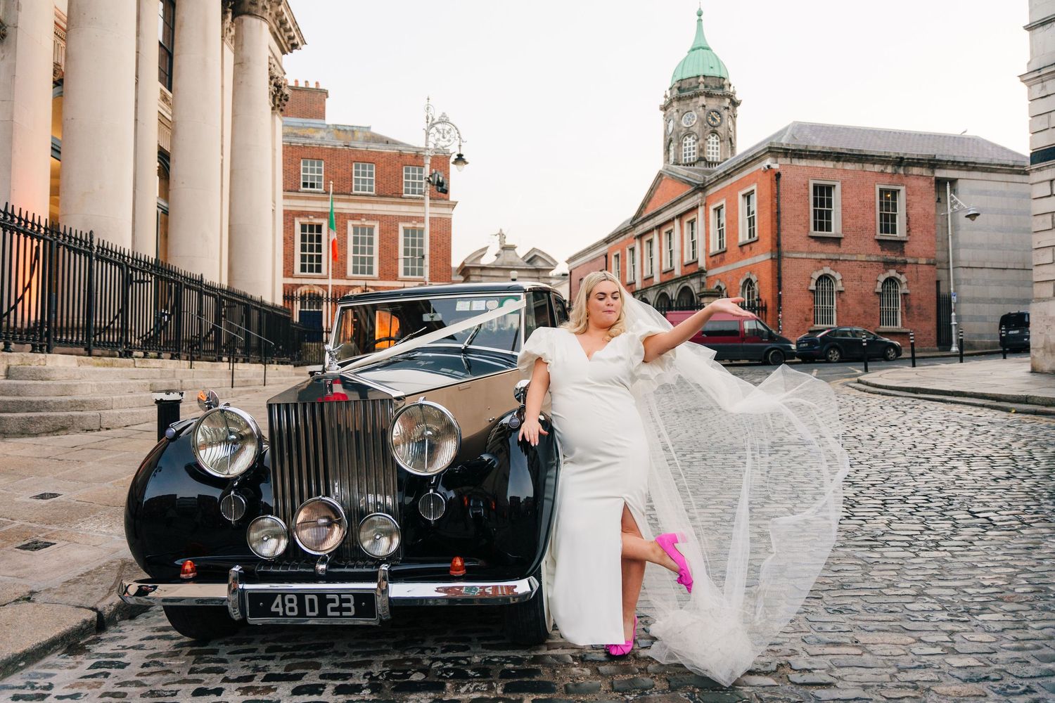 A classic black Rolls Royce car parked on cobblestone streets beside historic Georgian architecture in Dublin. City Hall Dublin Photographer