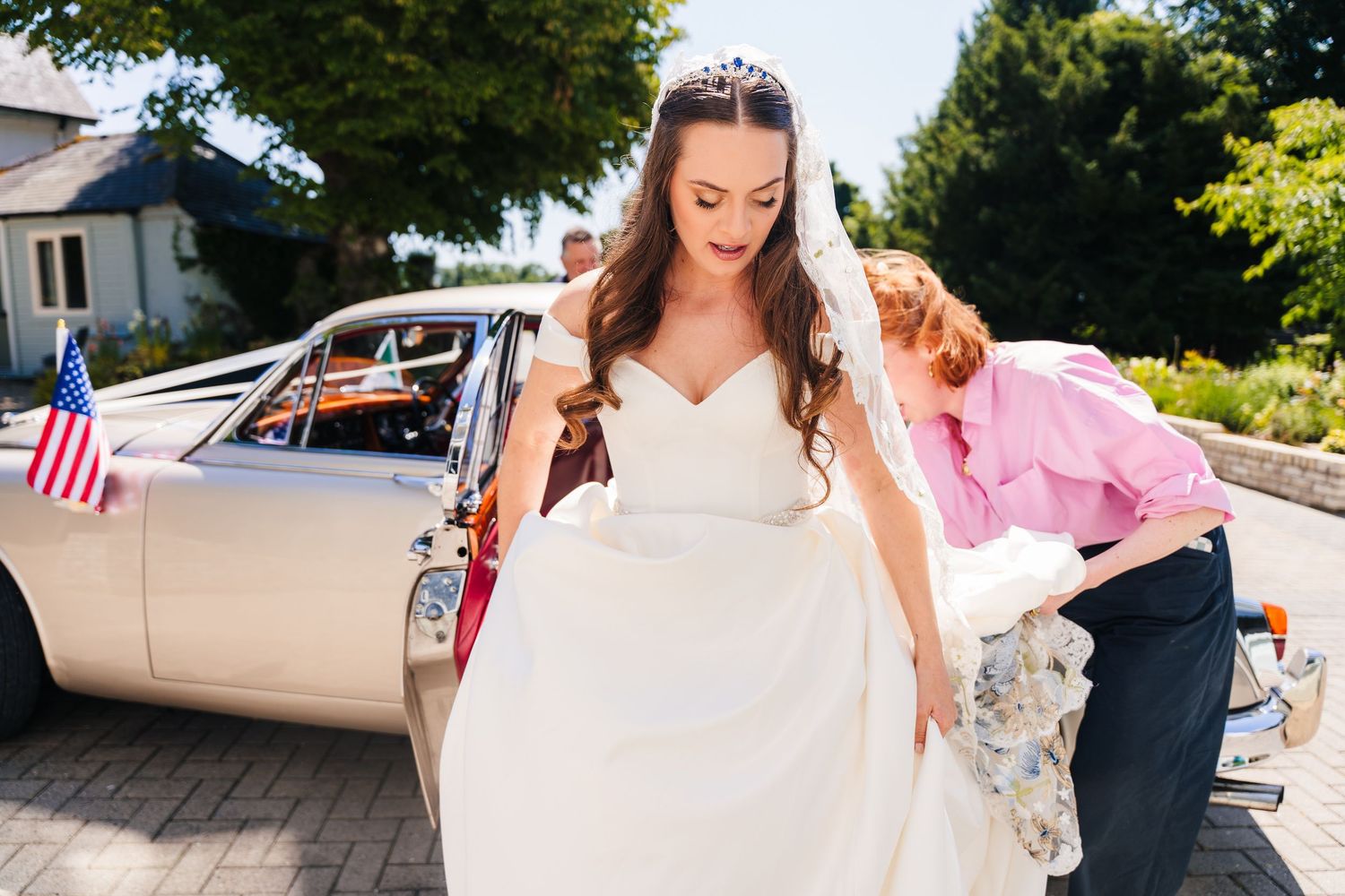 Poulaphouca Wedding photographer wicklow  Elegant wedding party exit with guests gathered outside on a sunny afternoon.
