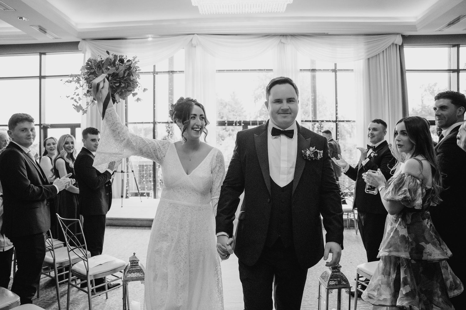 Wedding celebration inside a bright modern venue with guests mingling and dancing. Wedding Photography Trim Castle Ireland