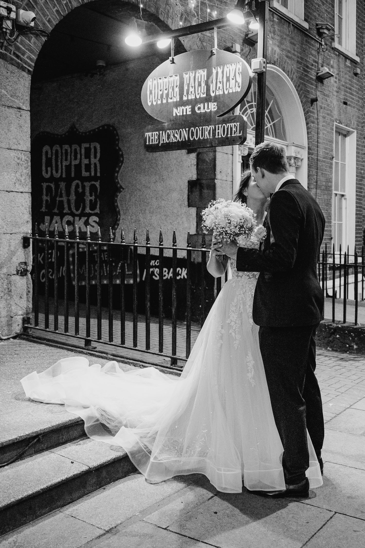Evening wedding portraits outside Copper Face Jacks with illuminated signage. Wedding PHOTOGRAPHER Dublin