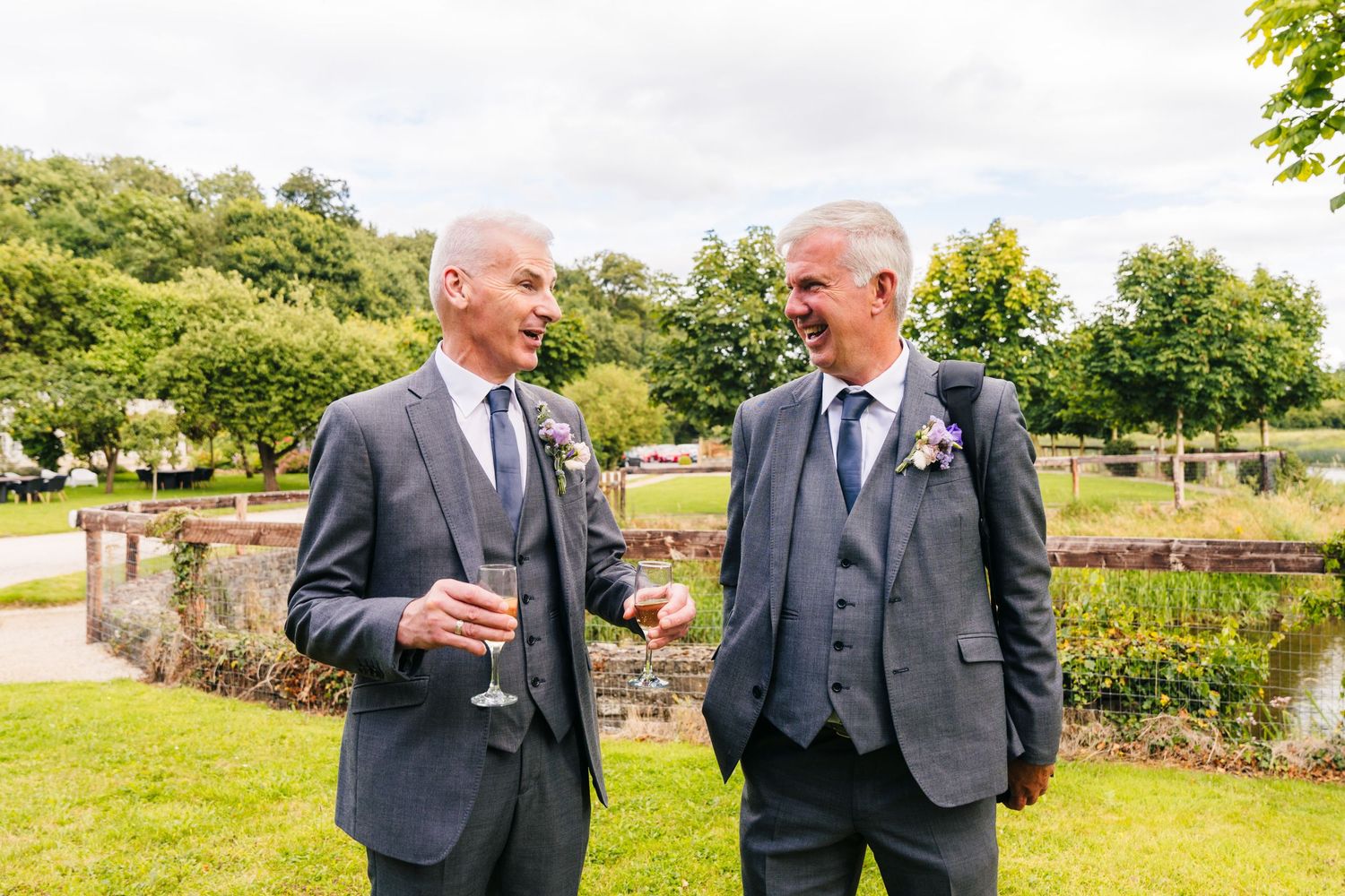 Millhouse slane wedding photographer dublin Group of wedding guests having conversations in a beautiful outdoor garden setting.