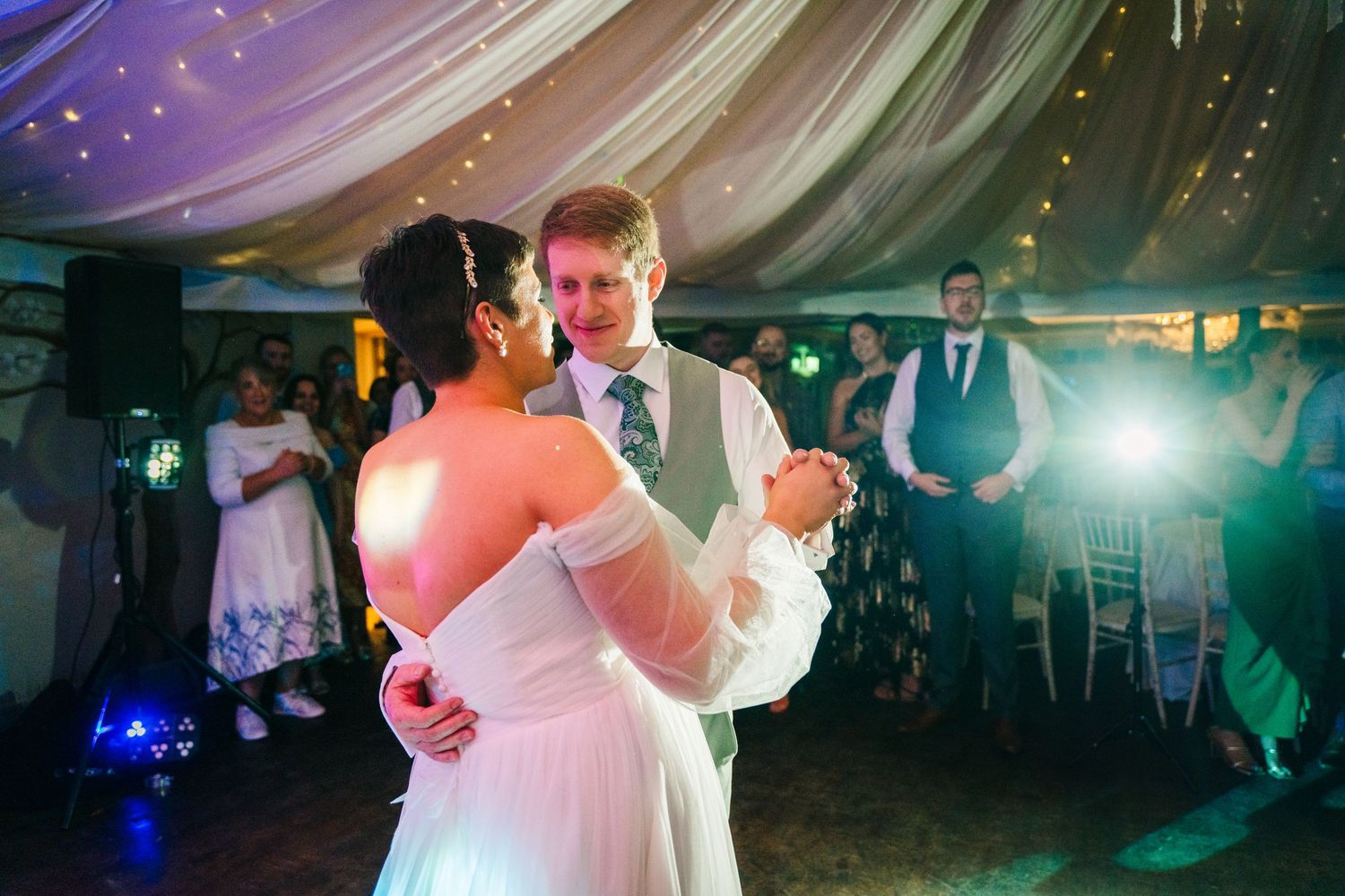 Millhouse slane wedding photographer dublin Wedding couple shares first dance under draped fabric ceiling with twinkling lights.