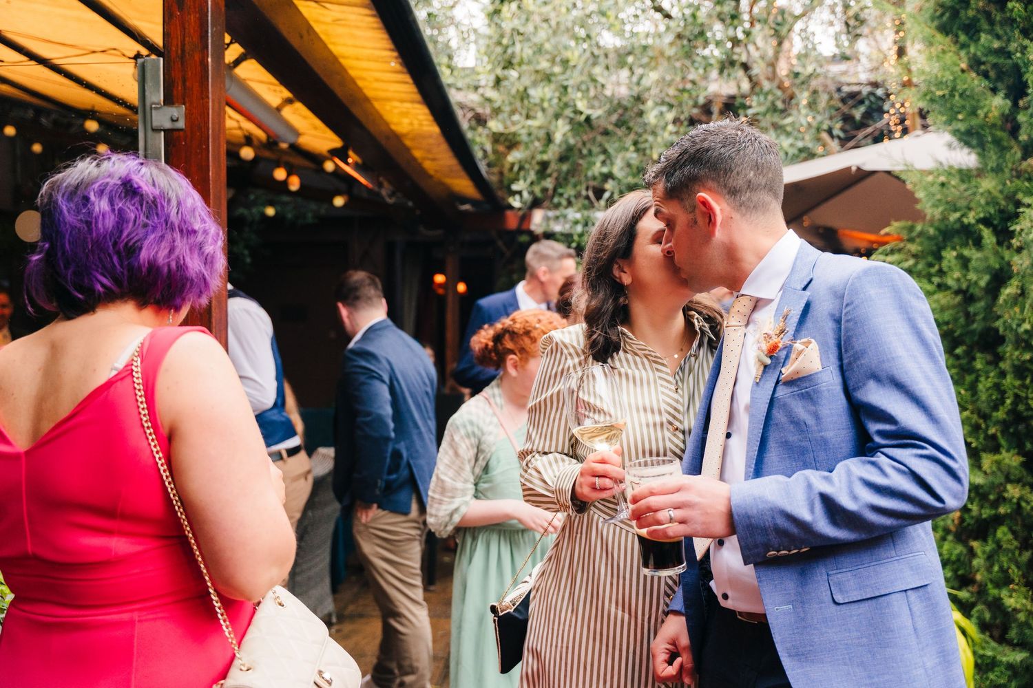 Wedding guests enjoying cocktail hour outside in a garden setting.Marco Pierre Dublin Wedding Photographer
