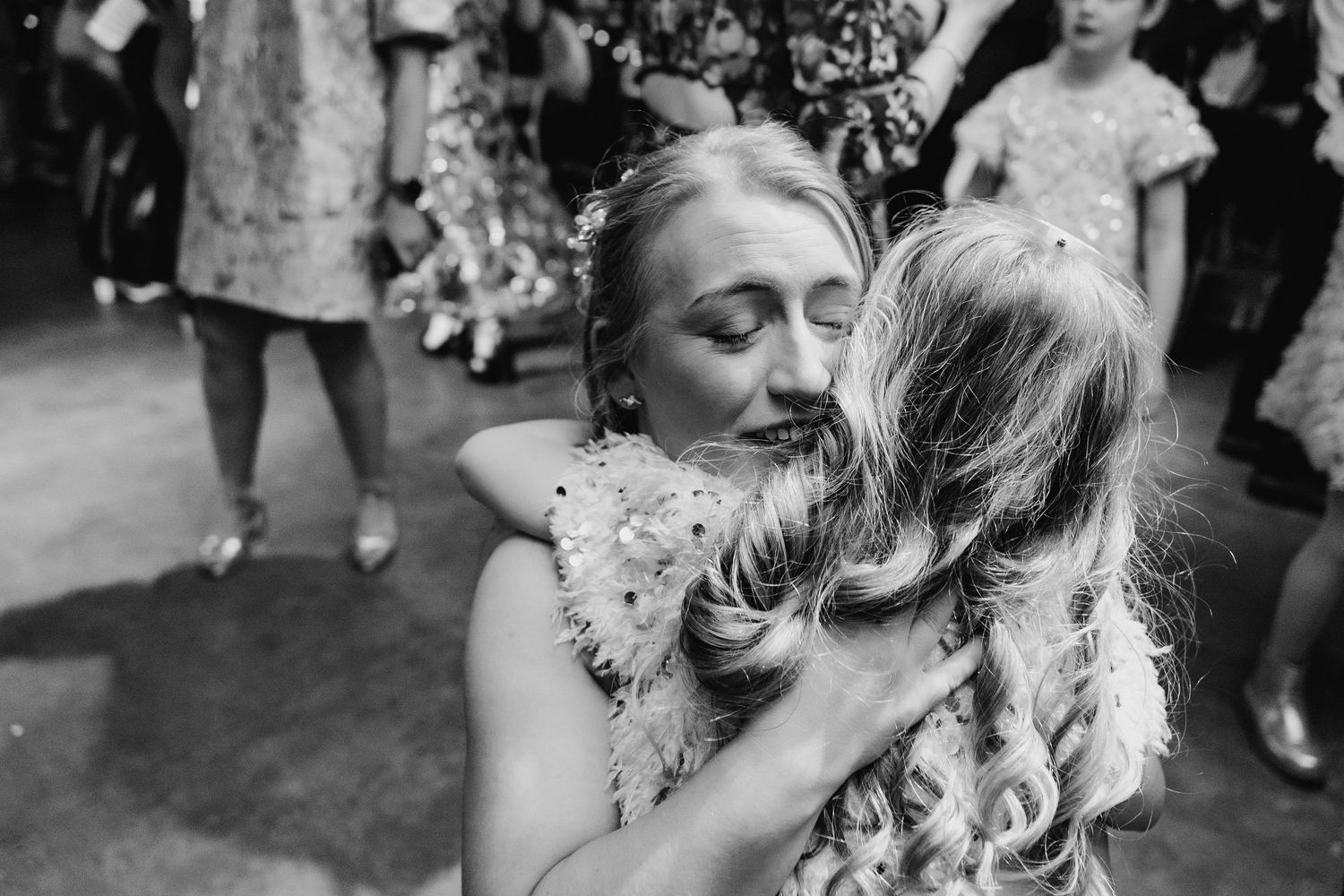An intimate black and white candid moment captured during a wedding celebration outdoors. Dublin wedding photogrAPher