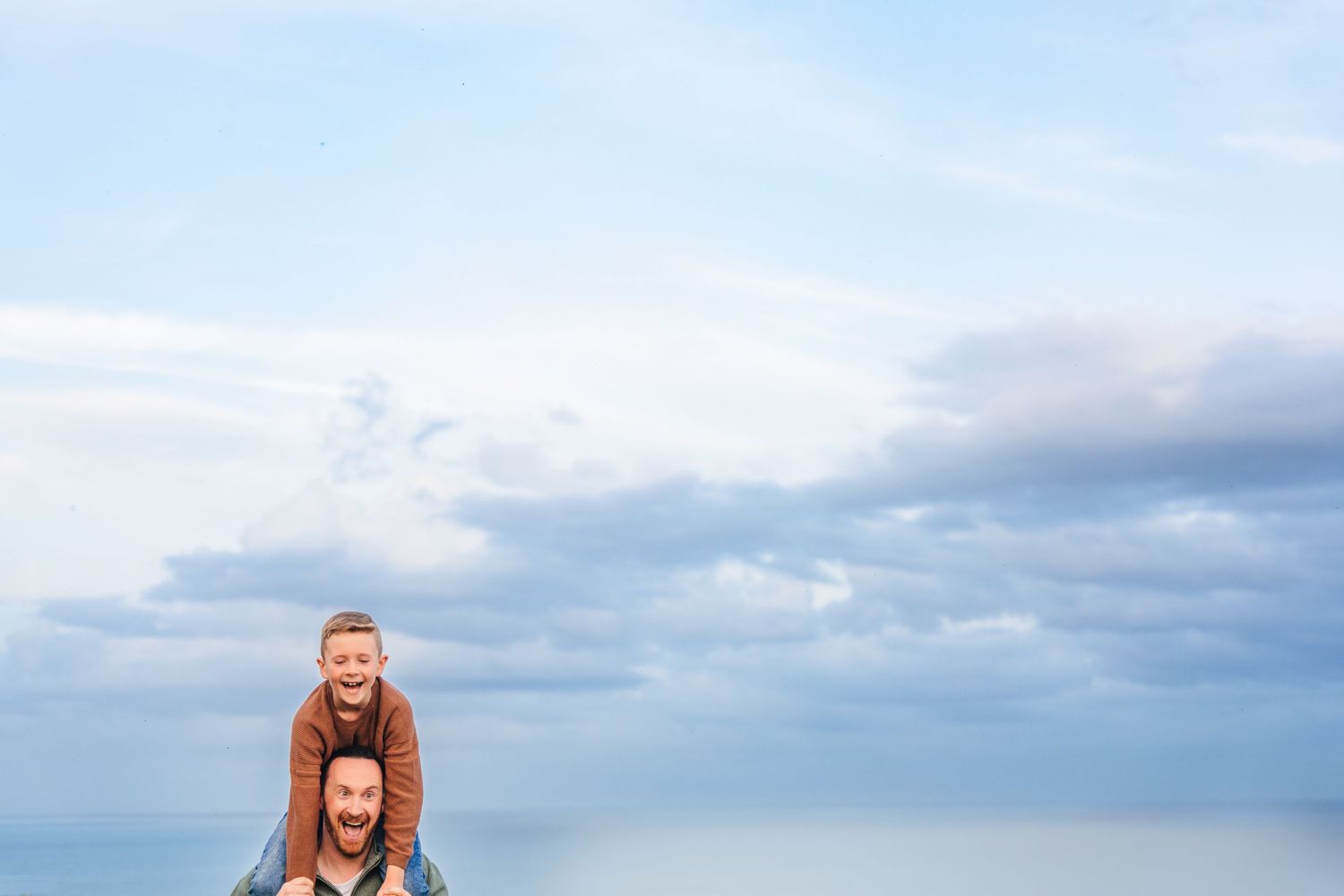 A serene landscape photography series showing a beach in winter with dramatic cloudy skies at sunset. family PHOTOGRAPHER Dublin