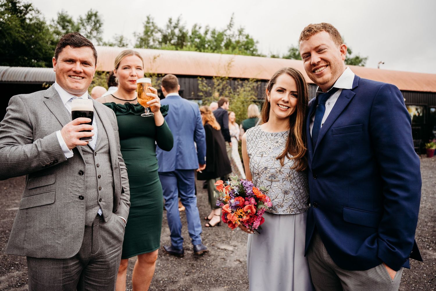 Wedding guests mingling and celebrating outdoors at a casual reception. Wedding photographer Dublin
