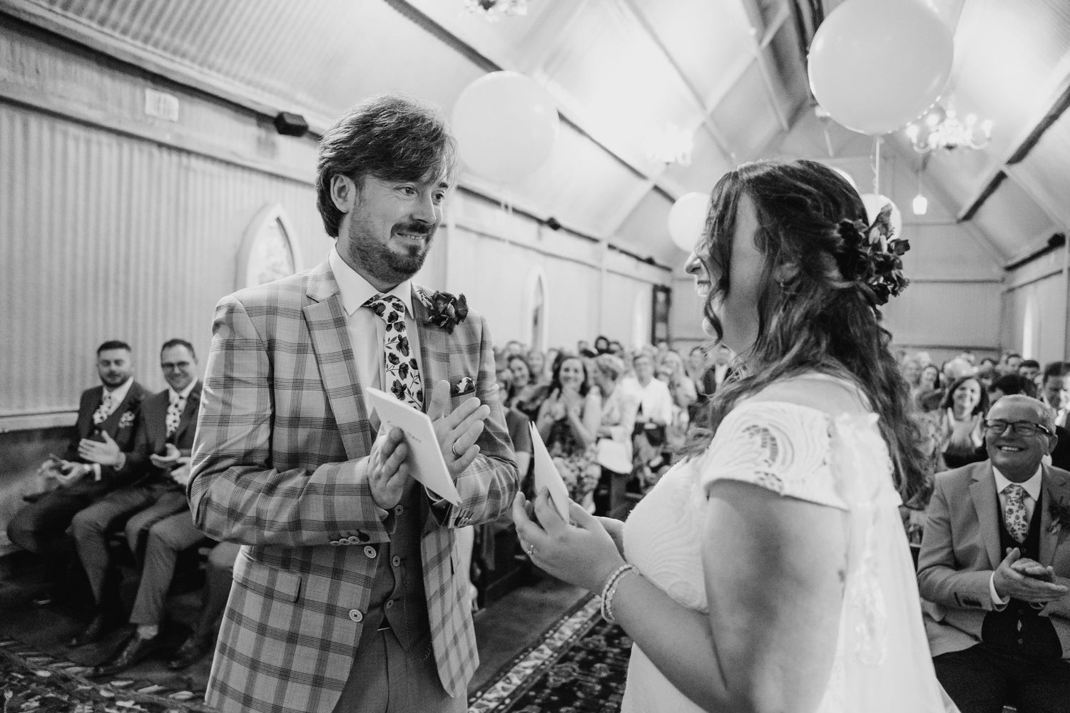 Wedding guests dancing and celebrating at an indoor reception venue. Wedding photographer Dublin