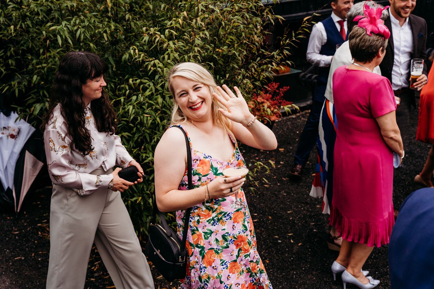 Wedding guests mingling outdoors in colorful attire during garden reception. Wedding photographer Dublin