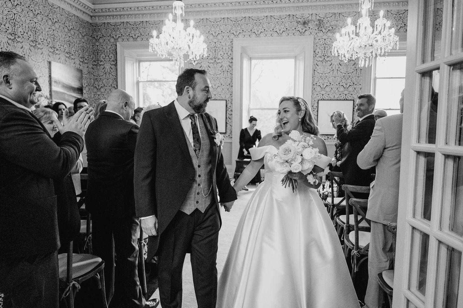 Wedding celebration in an elegant venue with crystal chandeliers and vintage-style wallpaper.  Virginia Park Lodge Wedding Photographer Cava