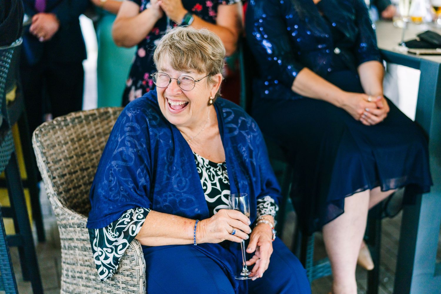 Poulaphouca Wedding photographer wicklow  Wedding guests enjoying themselves at a reception with people in blue attire.