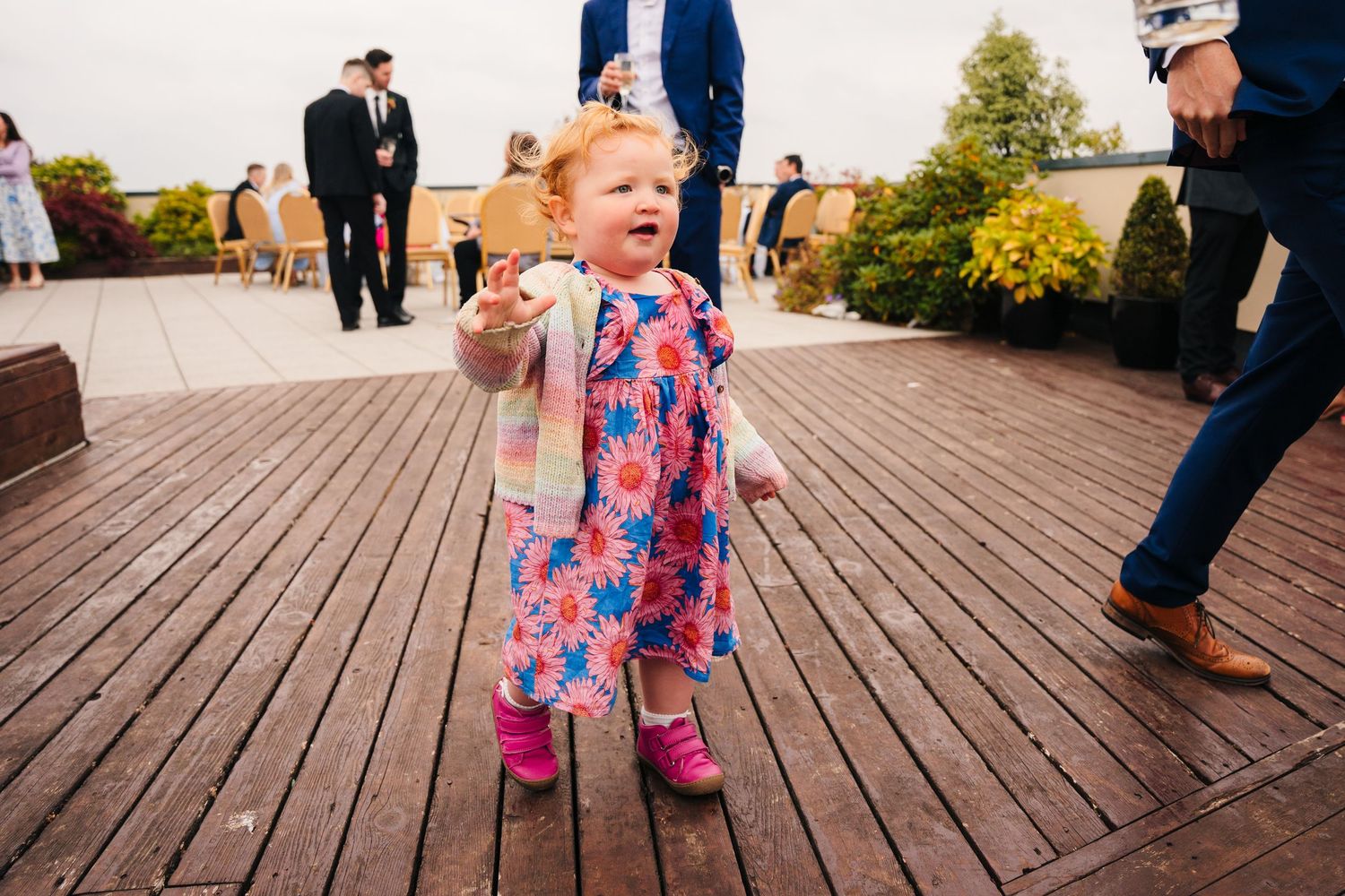 Young children in colorful attire running and playing on a wooden boardwalk.Wedding Photography Trim Castle Ireland