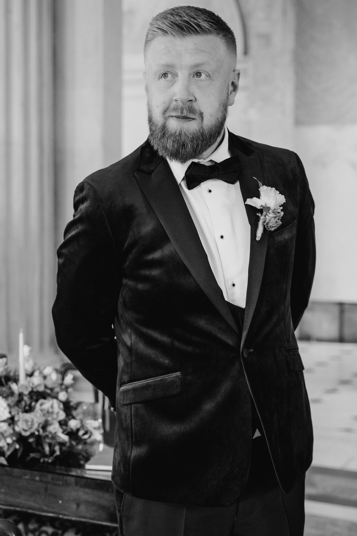 A groom in a black tuxedo poses in a series of emotional wedding portraits. City Hall Dublin Photographer