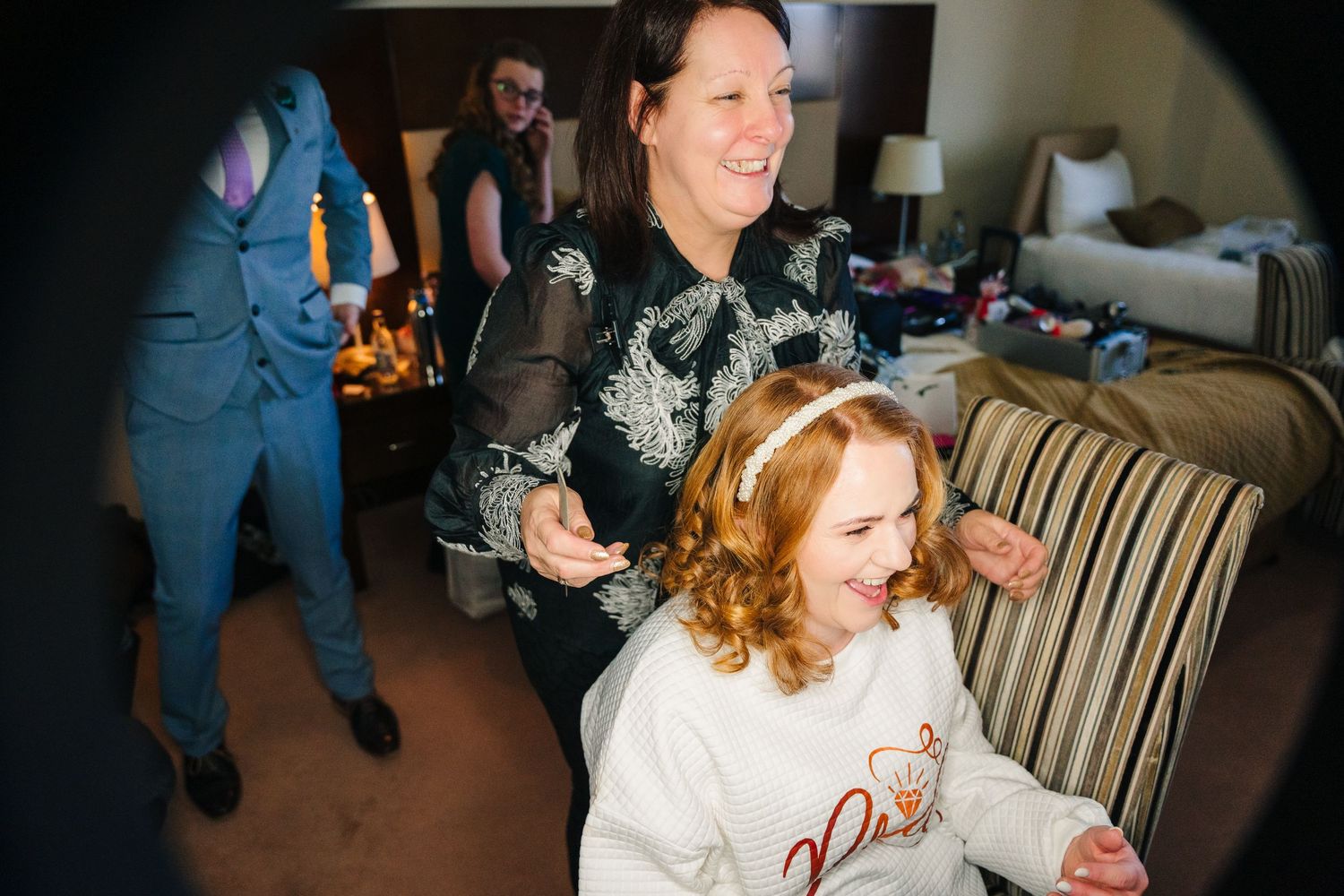Wedding guests share joyful moments and laughter during a reception celebration.  Wedding PHOTOGRAPHER Trim Castle