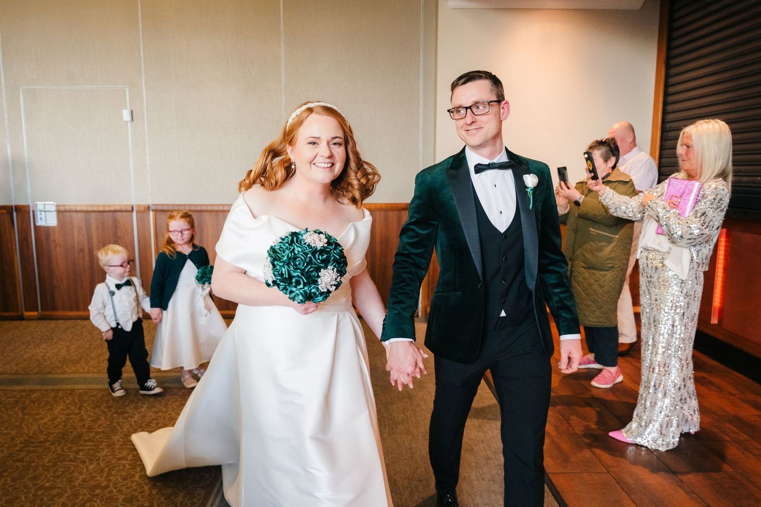 Couple celebrating during wedding reception in formal venue.  Wedding PHOTOGRAPHER Trim Castle