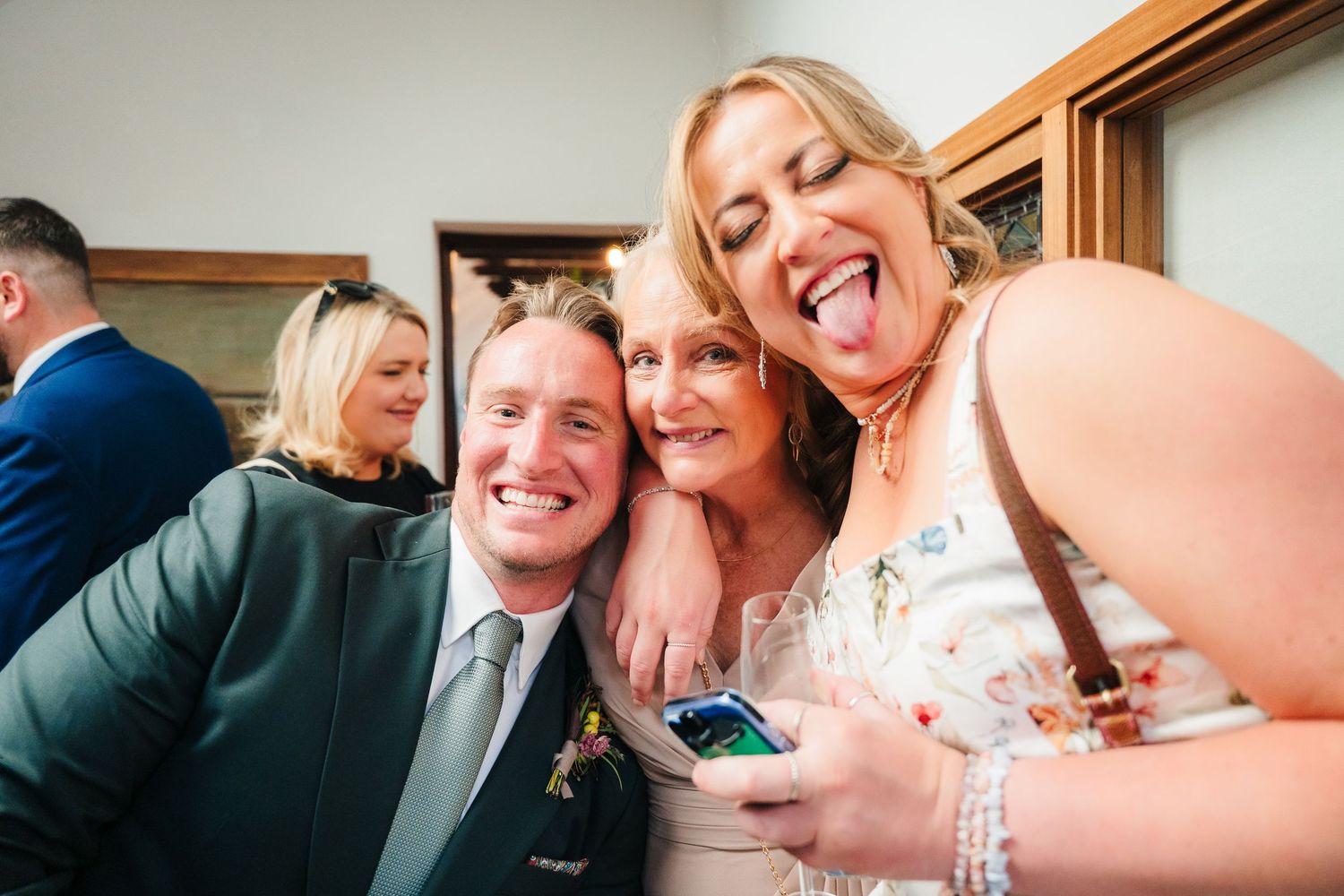 Wedding reception guests sharing joyful laughter during indoor celebration. Same sex wedding PHOTOGRAPHER Dublin