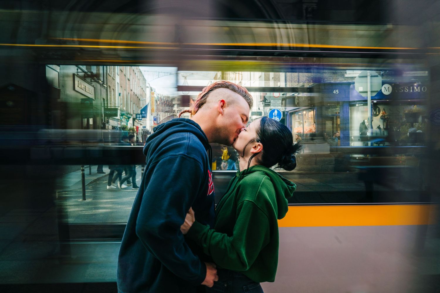 A romantic moment captured through glass with motion blur and city lights. PHOTOGRAPHER Dublin Ireland