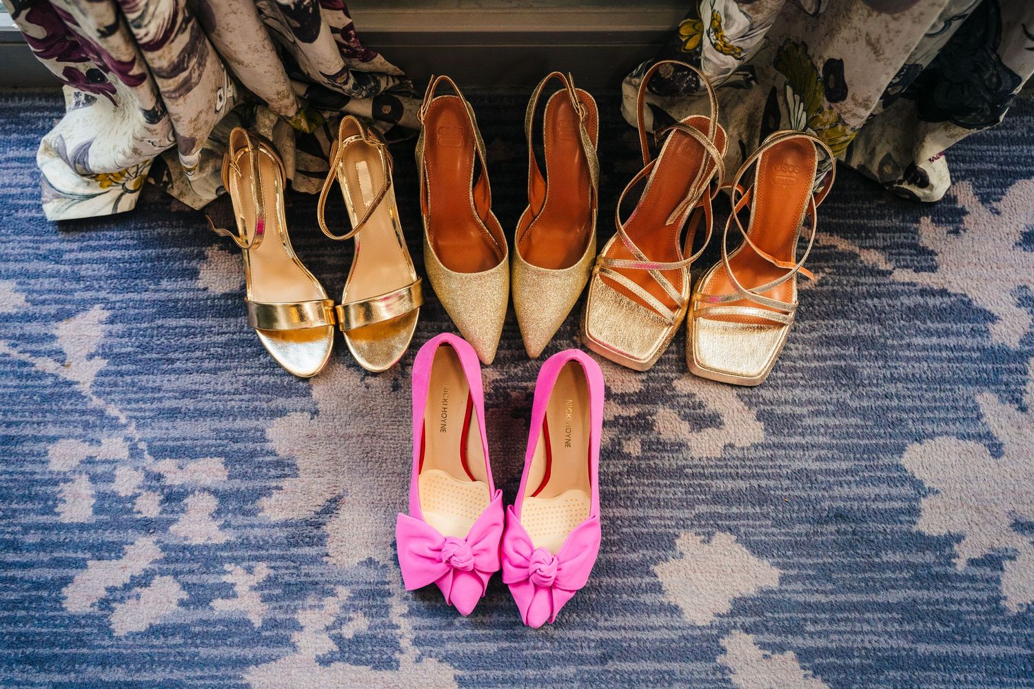 Collection of women's shoes arranged neatly on a blue carpet surface. Wedding photographer dublin