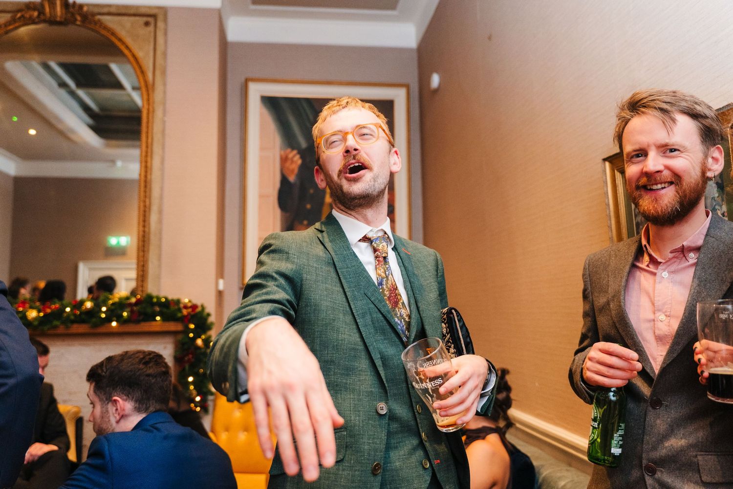 Wedding reception guests enjoying drinks and conversation at an indoor celebration. Stephens green club dublin Wedding photographer
