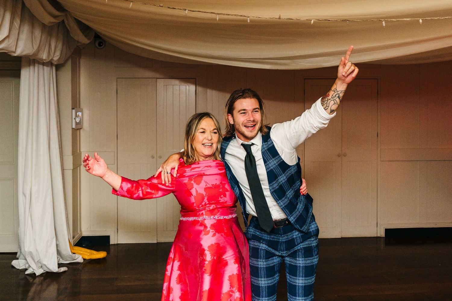 A couple striking celebratory poses at their wedding reception.  Virginia Park Lodge Wedding Photographer Cavan Dublin Ireland
