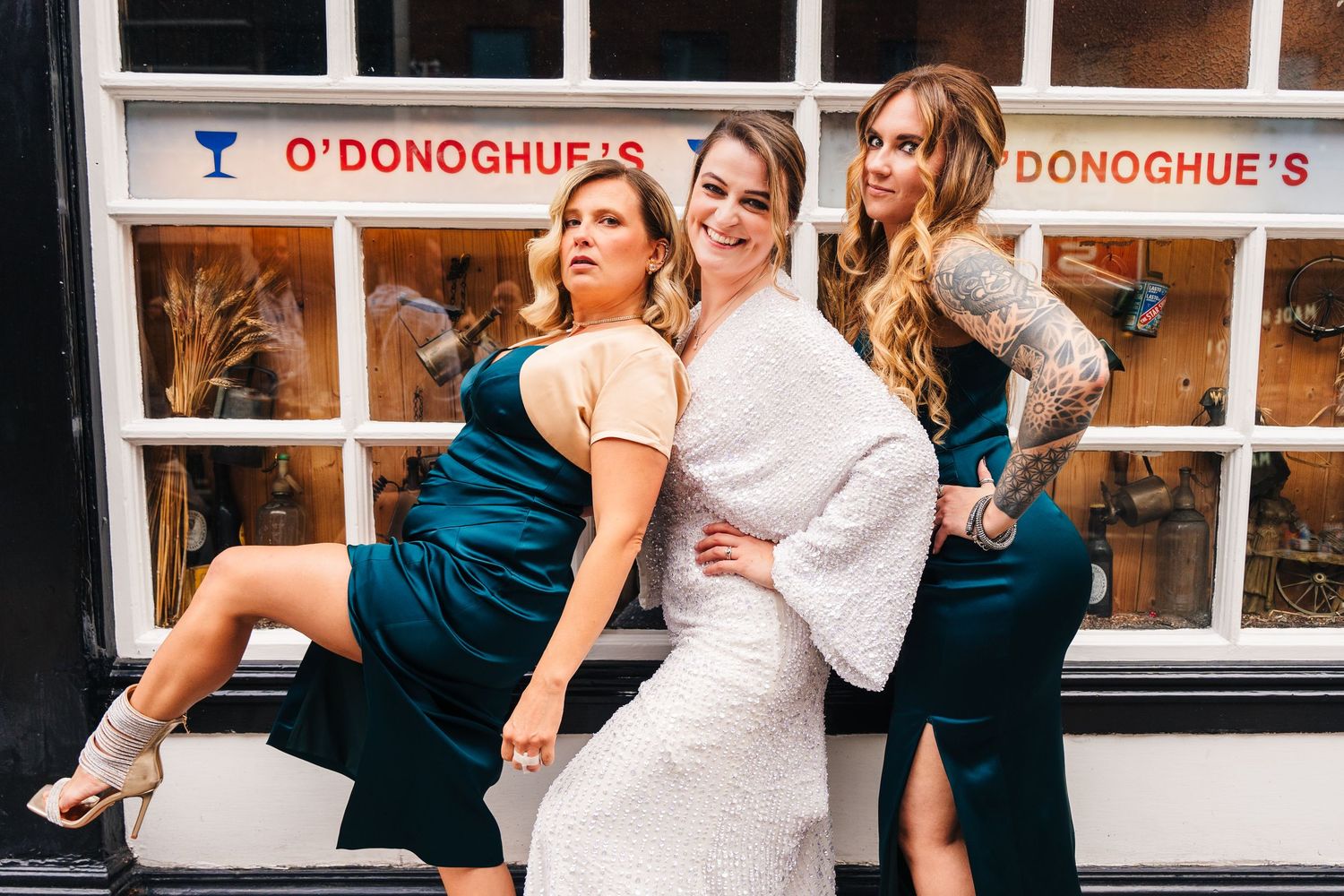 Wedding party enjoying drinks and celebrations outside O'Donoghue's pub. House Dublin Wedding Photographer