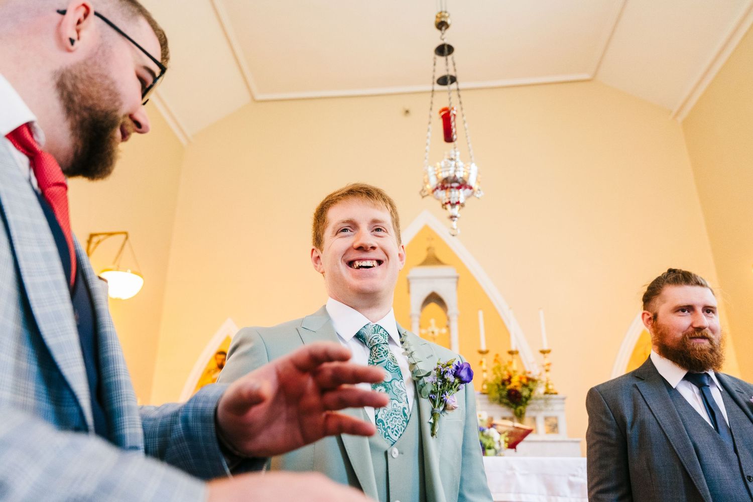 Millhouse slane wedding photographer dublin Candid moment of laughter shared during indoor wedding ceremony.