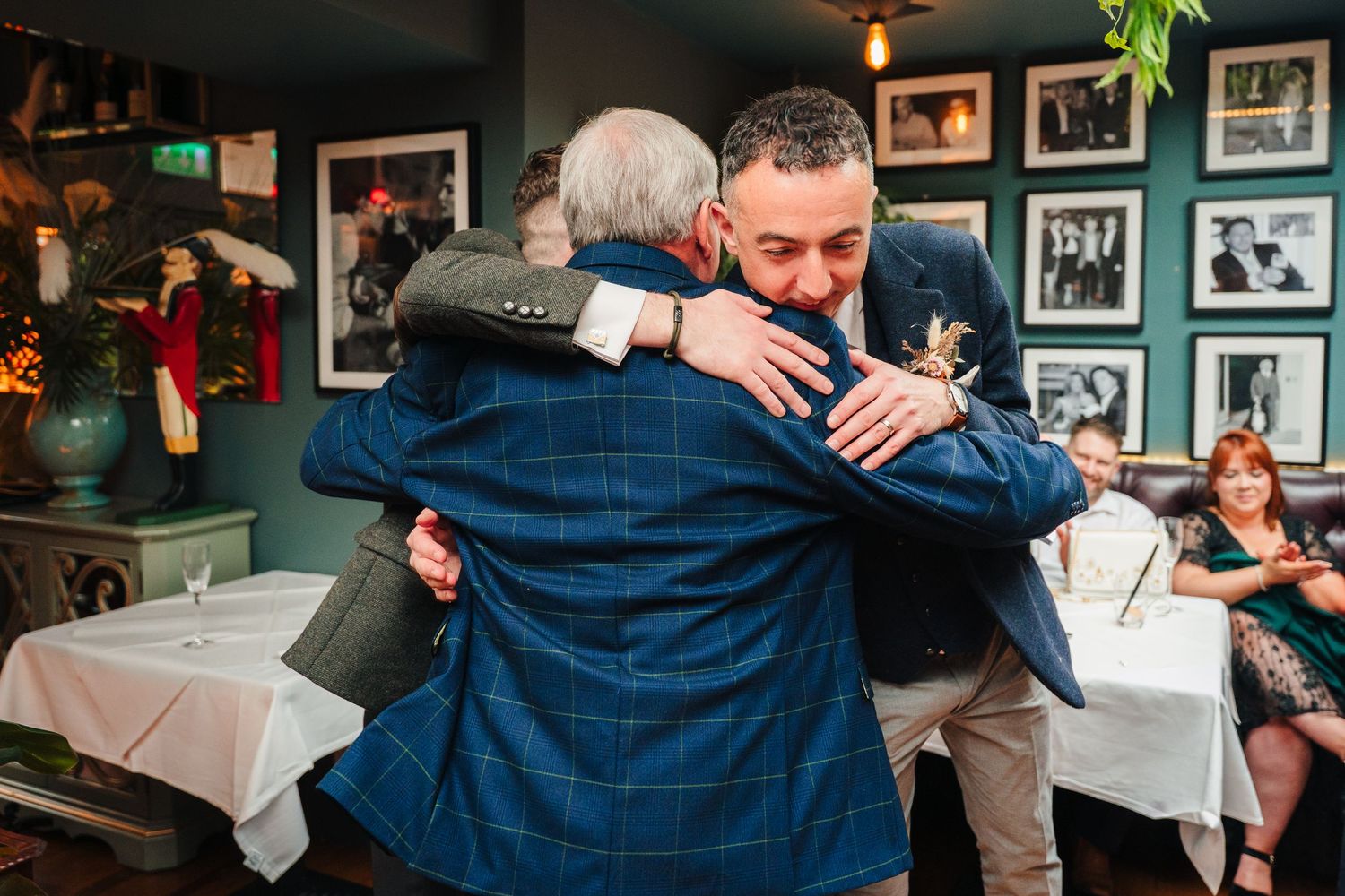 Emotional embrace between two people at restaurant celebration. Marco Pierre Dublin Wedding Photographer