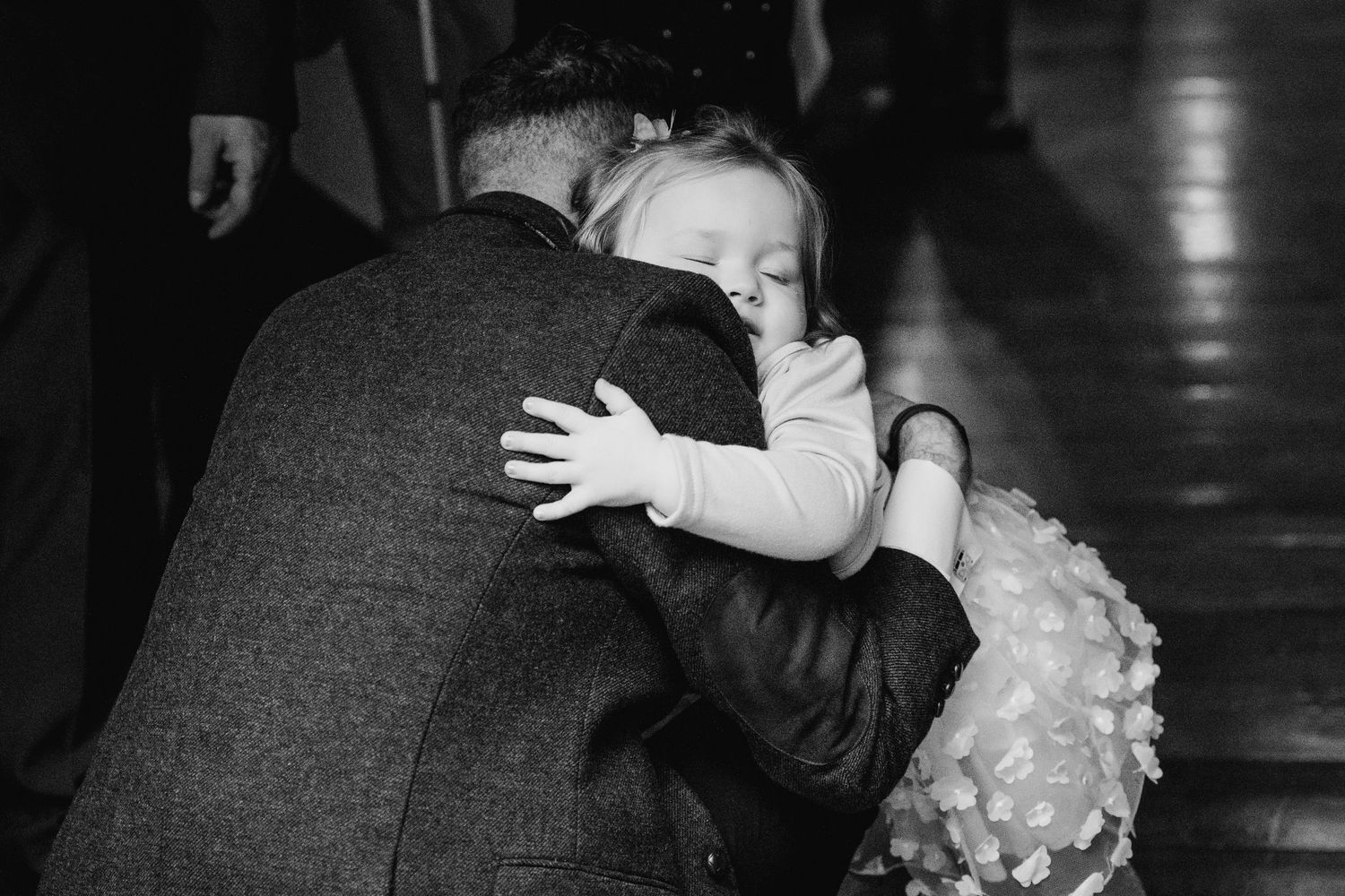 People dancing and hugging during a festive celebration. Marco Pierre Dublin Wedding Photographer