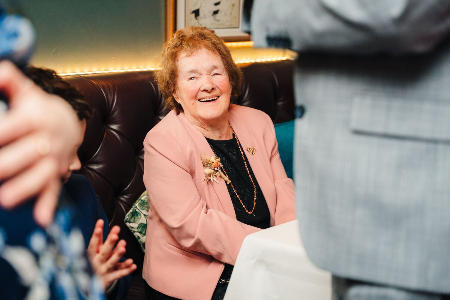 Wedding celebration candid moments captured showing guests laughing and socializing indoors. Marco Pierre Dublin Wedding Photographer
