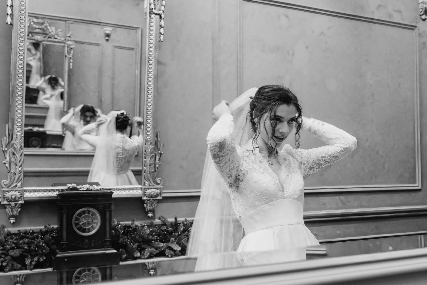 A series of black and white photos showing a person in a white dress getting ready in front of a mirror. Wedding Photographer Dublin