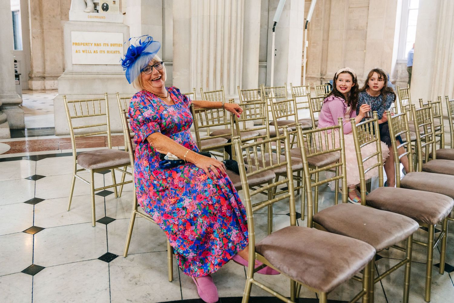 Wedding reception venue features elegant gold chairs and classical architectural details.  city hall dublin wedding photos