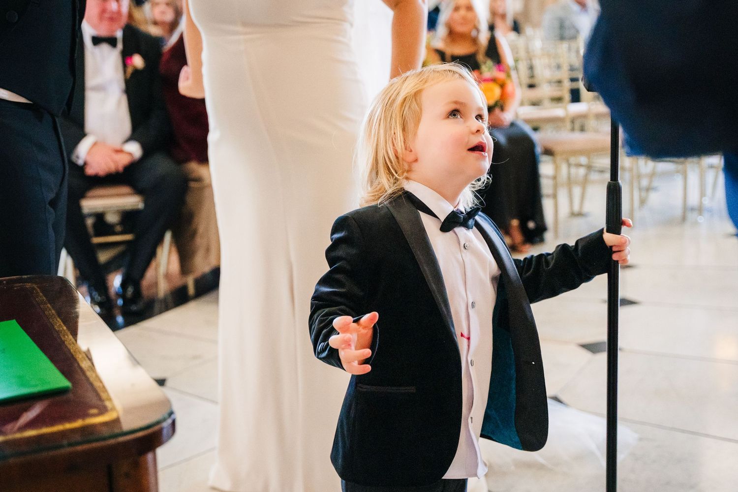 Young ring bearer in tuxedo performing during wedding ceremony.  Wedding photographer dublin