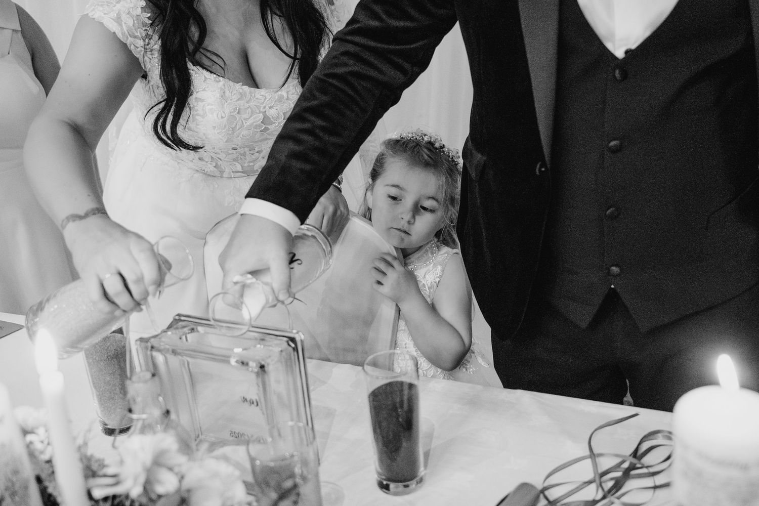 Close-up of table settings with elegant glassware and candles at a formal wedding reception. Wedding photographer dublin