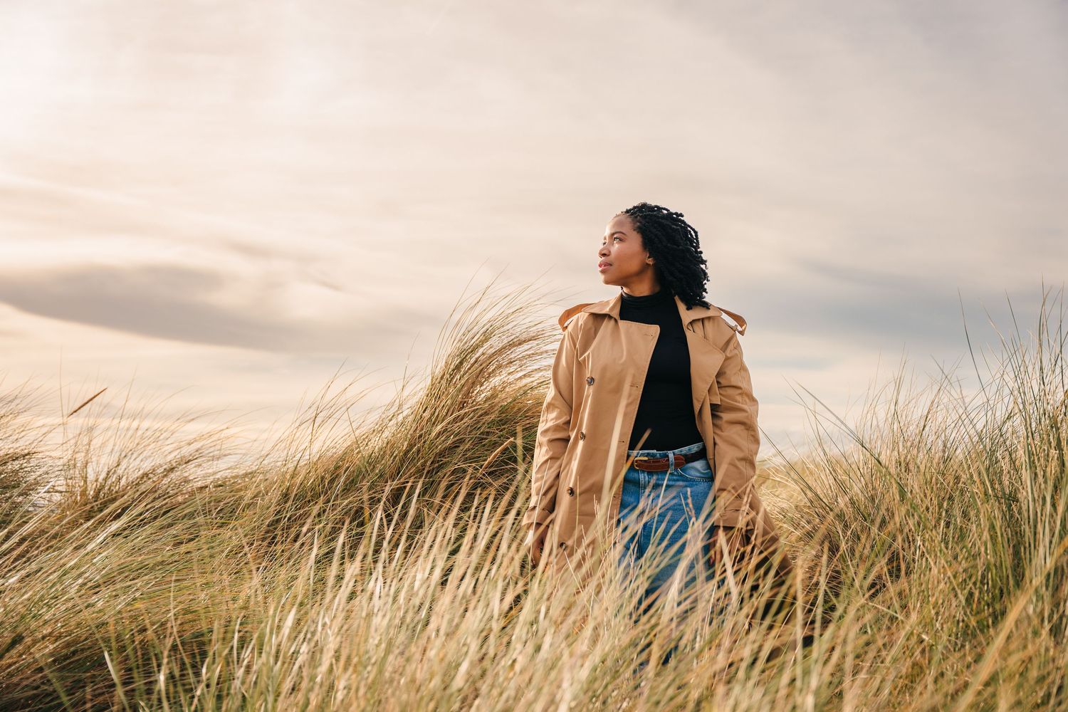Windswept scene in tall grass with dramatic cloudy sky background. Dublin professional headshots photographer