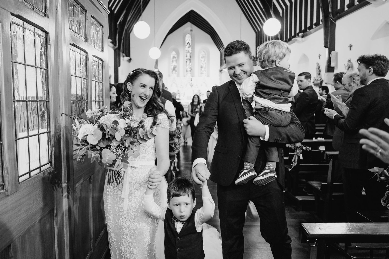 Church wedding ceremony with dramatic lighting and architectural details.