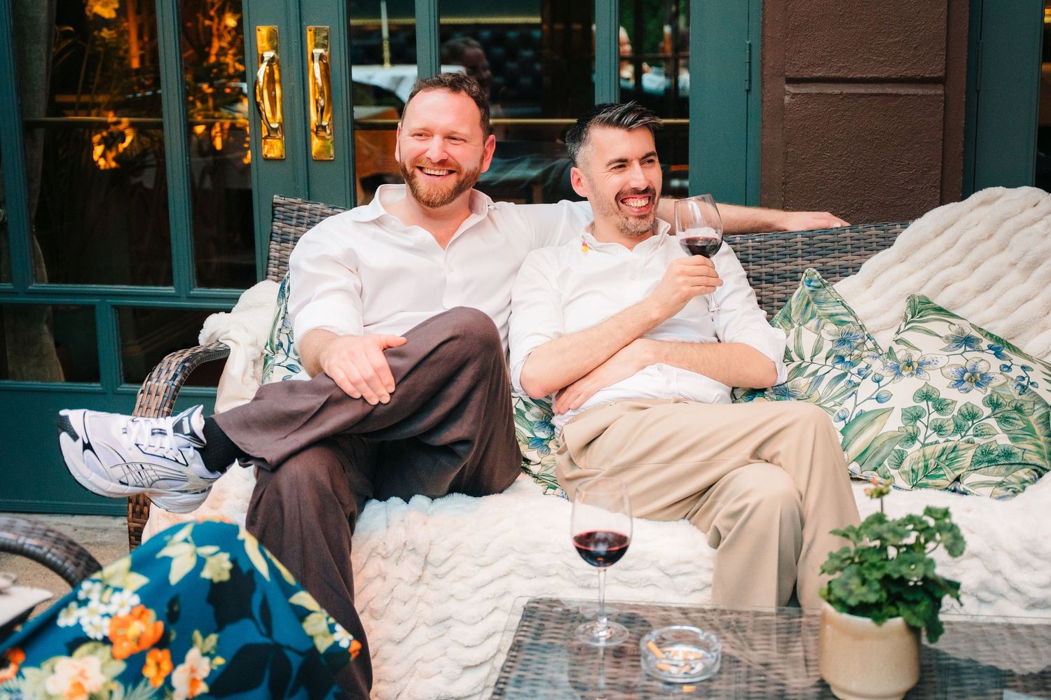 Party guests relaxing on outdoor patio furniture during evening event. Marco Pierre Dublin Wedding Photographer