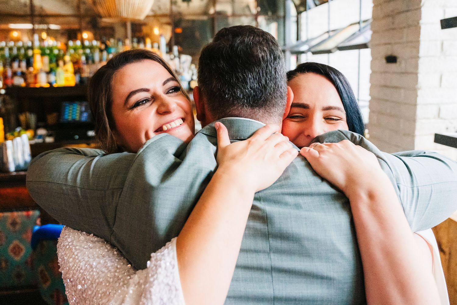 An emotional group embrace captured at a wedding celebration. House Dublin Wedding Photographer