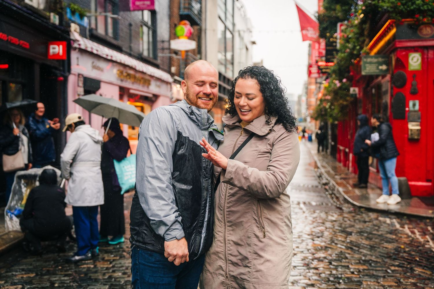 A couple shares a romantic moment dancing on a cobblestone street of Montmartre in Paris. Proposal Dublin Photographer