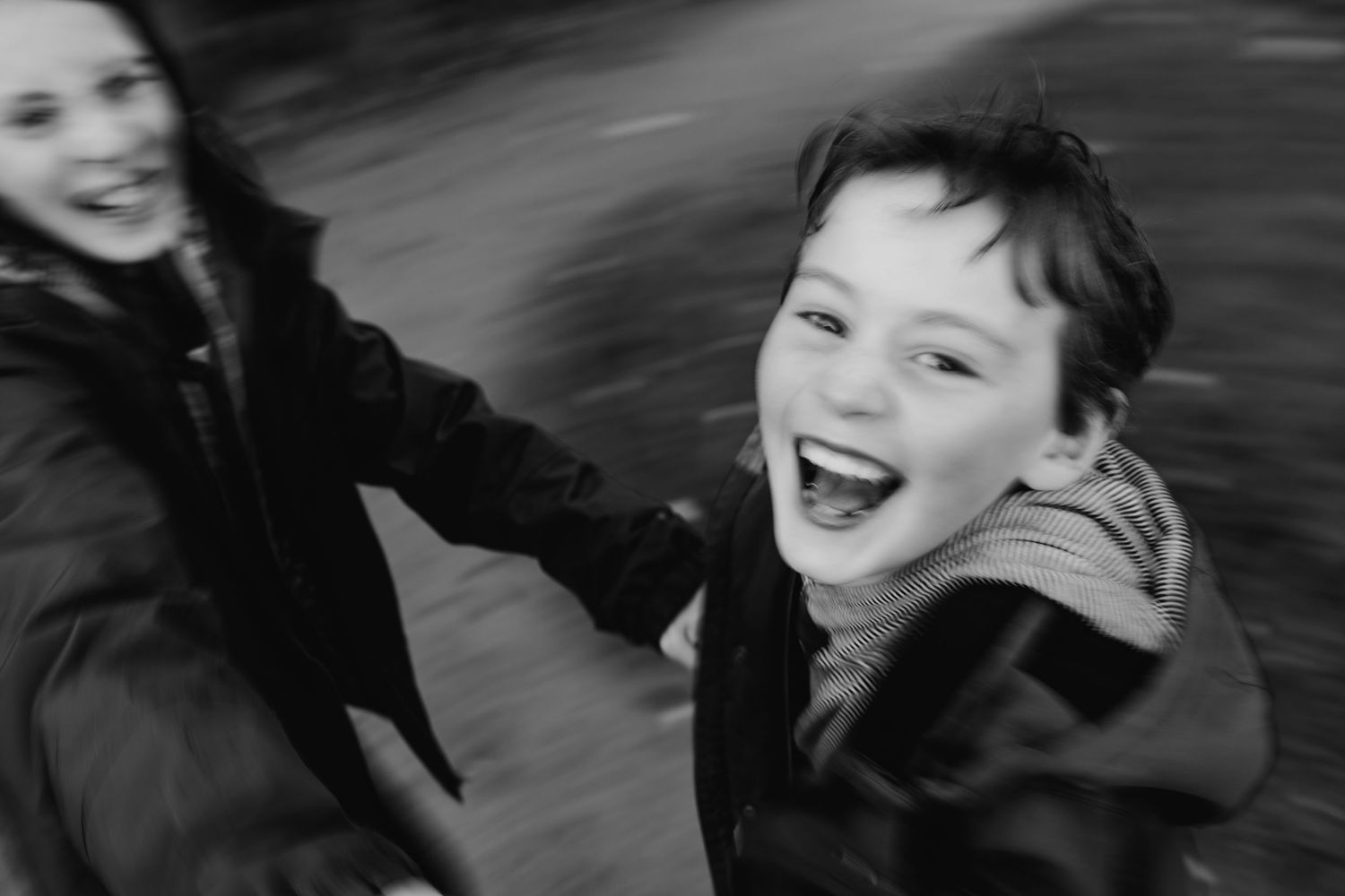 Close-up black and white portrait of someone looking pensive and laughing while glancing to the side. family PHOTOGRAPHER Dublin