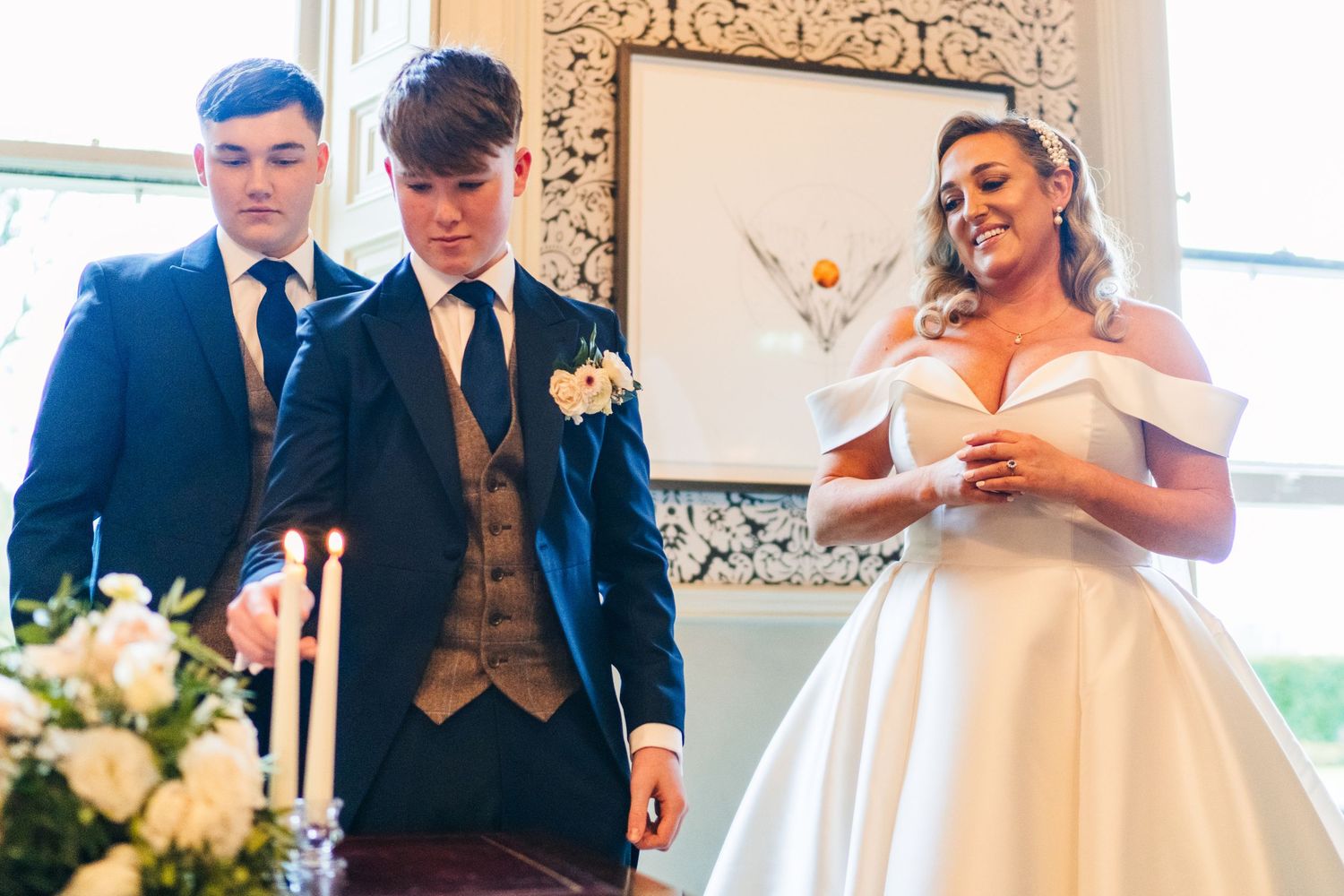 Wedding guests in formal attire celebrating during reception in an elegant venue.  Virginia Park Lodge Wedding Photographer Cavan Dublin Ire