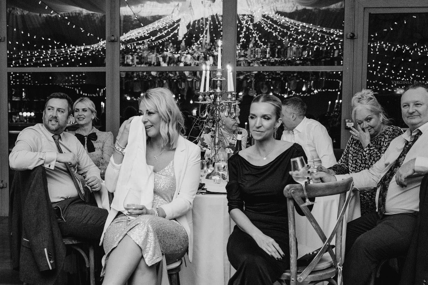 Wedding guests enjoying themselves at a reception with string lights overhead.  Virginia Park Lodge Wedding Photographer Cavan Dublin Irelan