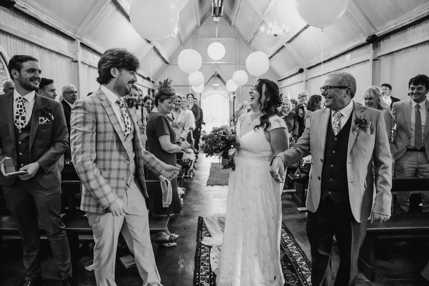 Black and white wedding reception photos showing dancing and celebration under white tent decor. Wedding photographer Dublin