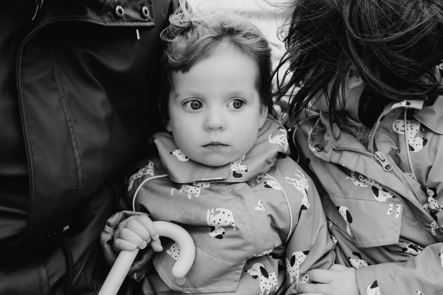Black and white portrait of a young child in winter clothing. PHOTOGRAPHER Dublin