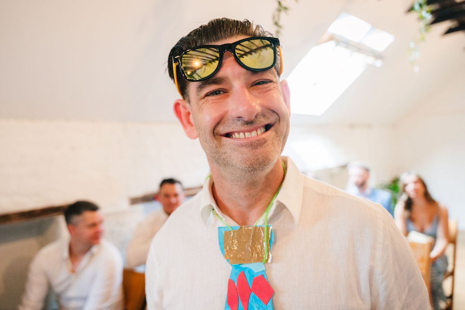 Guests enjoying playful moments at a sunny outdoor celebration. Same sex wedding PHOTOGRAPHER Dublin