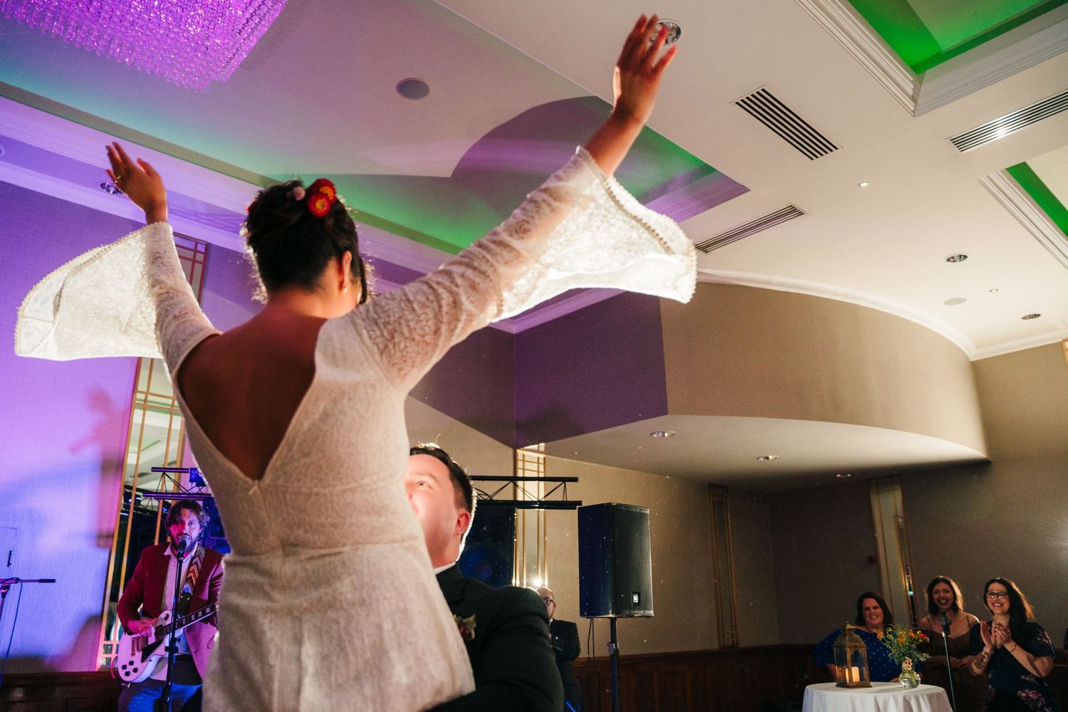 Wedding celebration in a ballroom with purple and green mood lighting.Wedding Photography Trim Castle Ireland