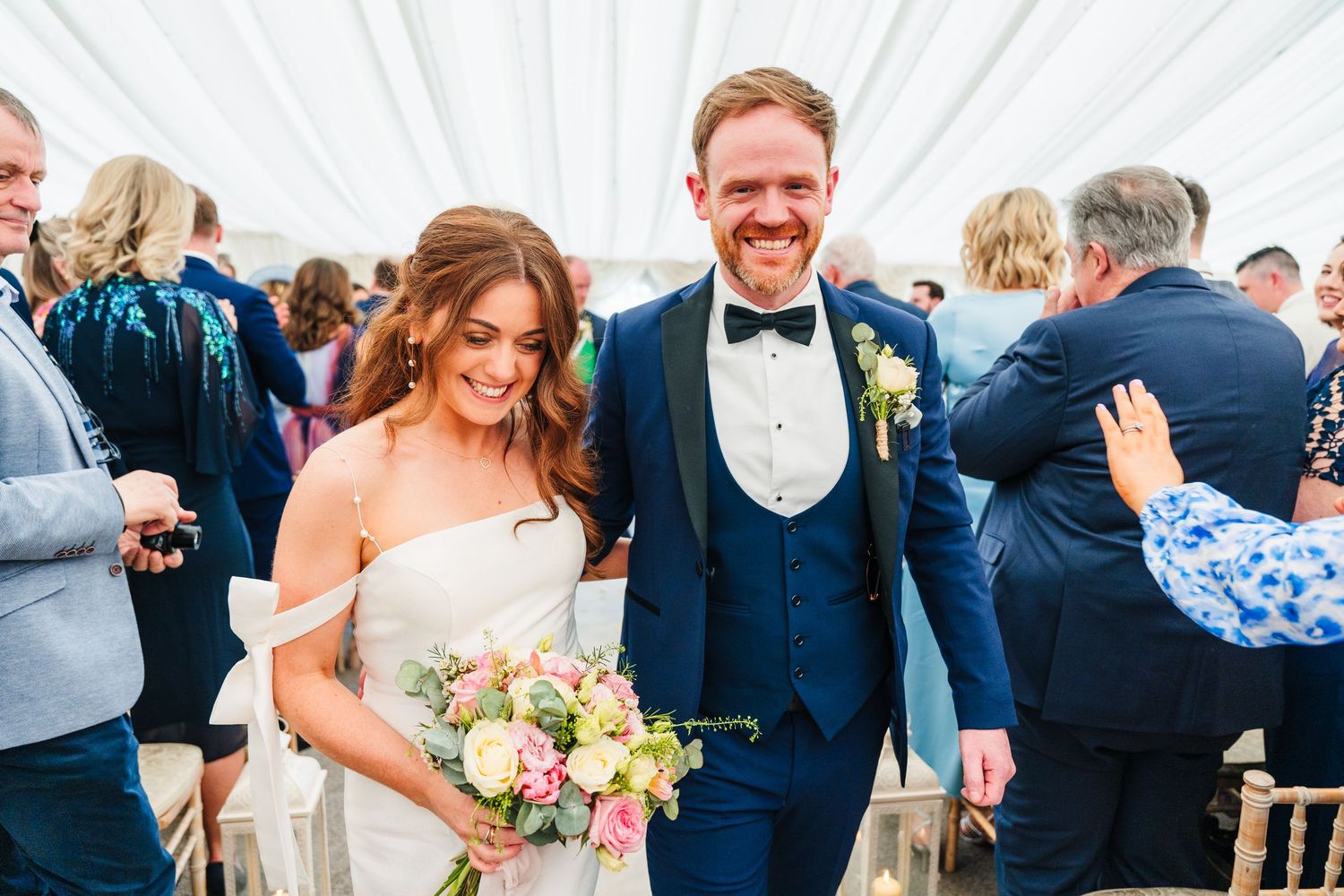 Castle Leslie Wedding Photographer Dublin Wedding party celebrates joyfully outdoors with dancing and laughter.