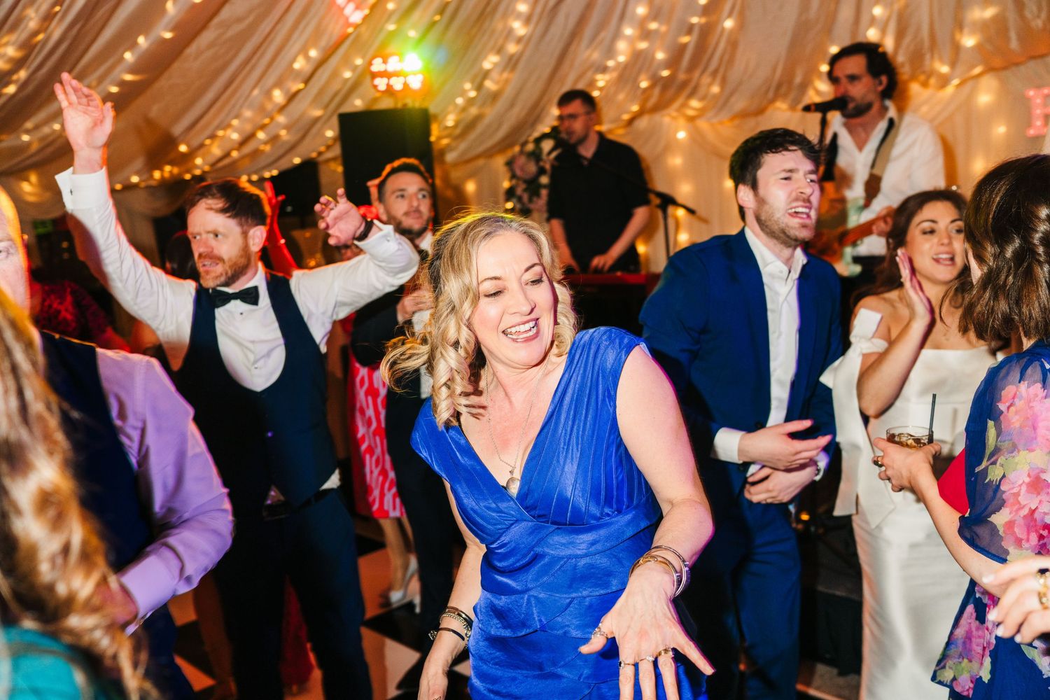 Castle Leslie Wedding Photographer Dublin Wedding reception dance floor filled with guests celebrating under twinkling lights and decor.