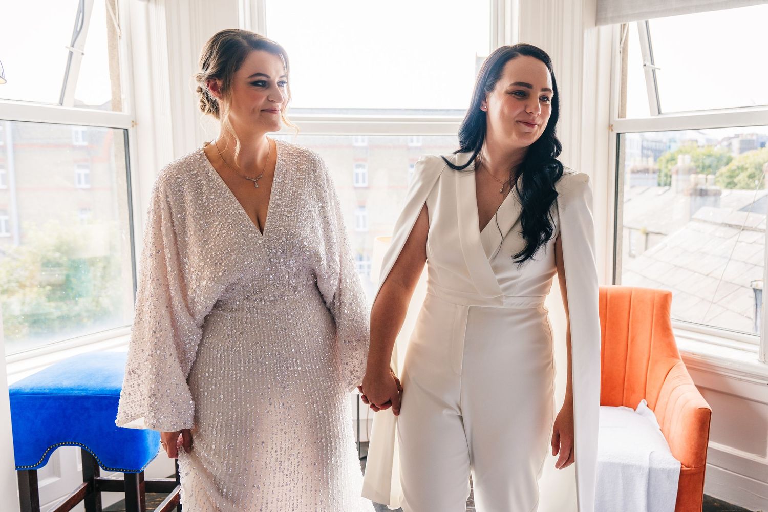 Wedding party members in white dresses gather in a sunlit room during pre-ceremony preparations. House Dublin Wedding Photographer