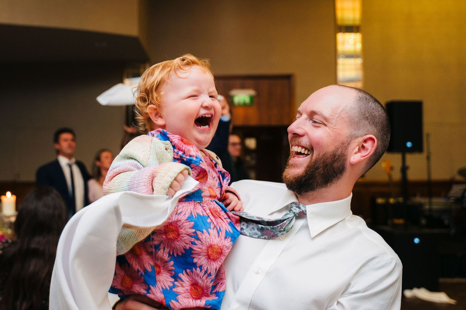 Candid moment of laughter shared during wedding reception.Wedding Photography Trim Castle Ireland