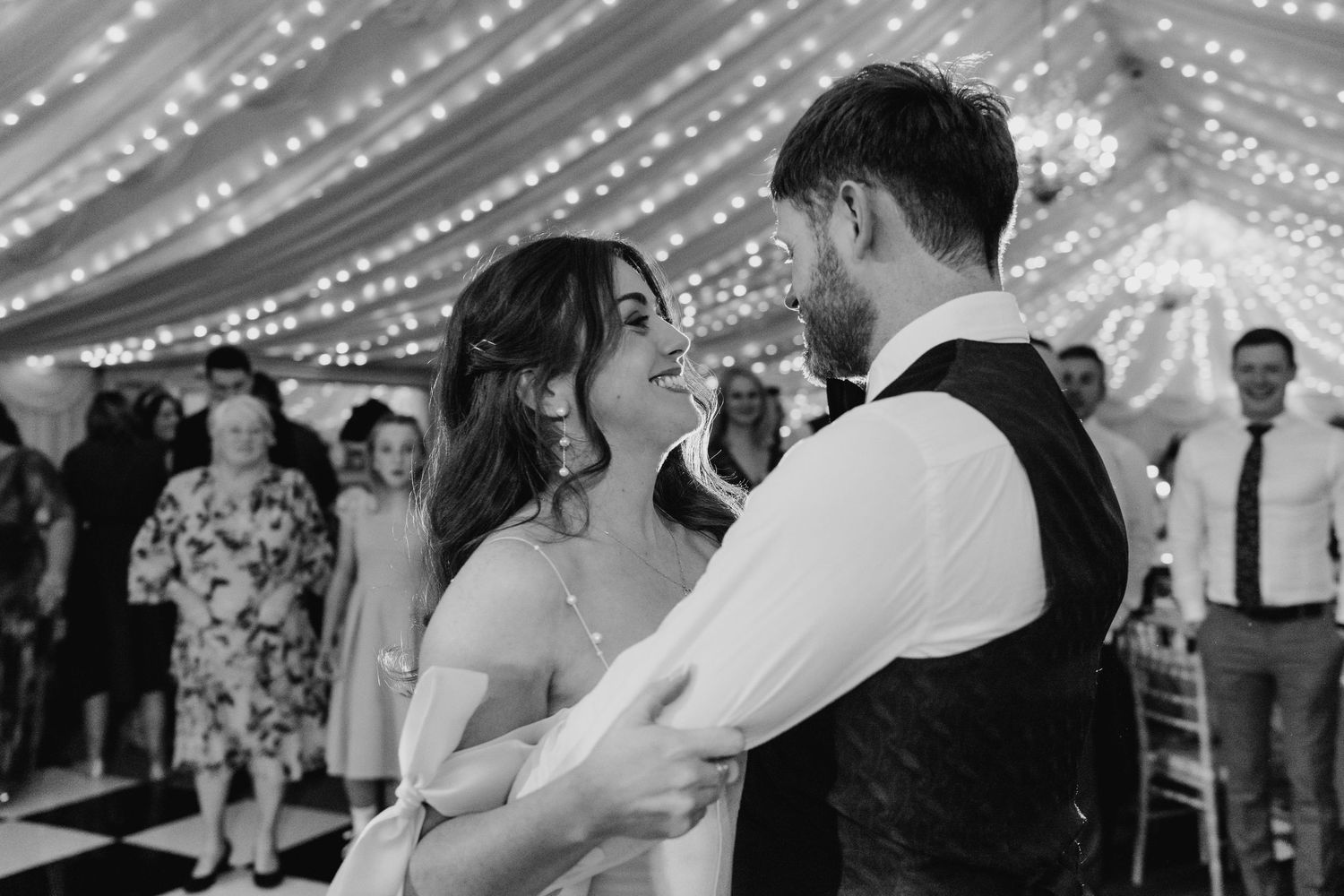 Castle Leslie Wedding Photographer Dublin Romantic dance under twinkling lights at evening wedding reception.